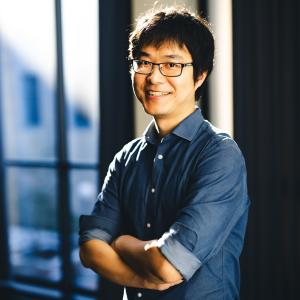 Chenshu Liu stands for a portrait smiling at the camera