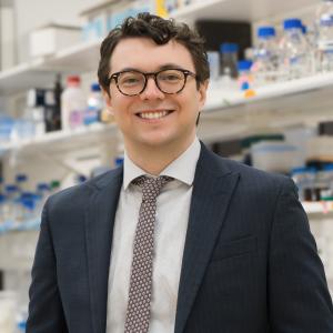 Assistant professor Darrin Schultz standing in a lab for his portrait