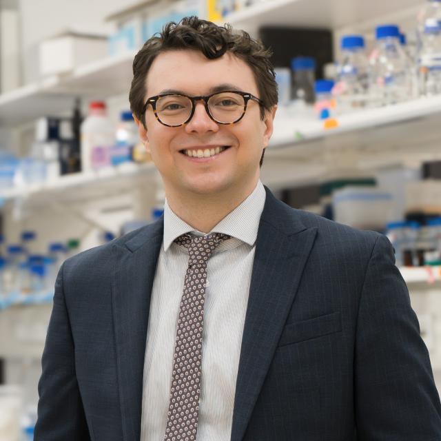 Assistant professor Darrin Schultz standing in a lab for his portrait